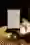 Image of a menu from the Makidan restaurant on the table. A flower stands decoratively in a vine leg and a modern placemat and a silver spoon are slightly out of focus.