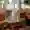 A white dog with long fur stands in the stylishly furnished lobby of the Hotel Ritter Durbach and looks into the camera.