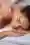 Closeup happy woman with eyes closed enjoying back massage spa